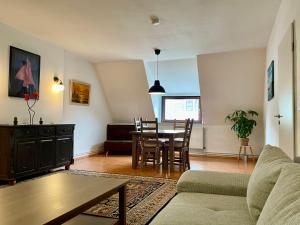 Una sala de estar con una mesa y un comedor. en Bötchen - modern, zentral, für TreppensteigerInnen, en Bremerhaven