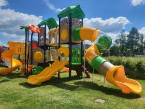 a group of playground equipment on the grass at Willa Skałka in Białka Tatrzanska