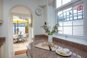 a kitchen with a counter with a cutting board and a window at Budleigh Burrow in Budleigh Salterton