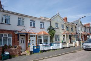 a row of houses on a street with a car at Budleigh Burrow in Budleigh Salterton