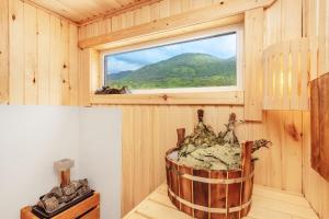 a wooden room with a window and a barrel at Отель Taminik in Gagra