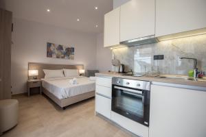 a small kitchen with a bed in a bedroom at Casa de Lapel Kallithea in Kallithea Halkidikis +15 photos