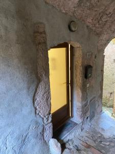 a door in a stone wall with a window at Casa di Filippo in Arcola