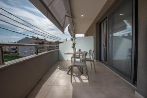 a balcony with a table and chairs on it at Casa de Lapel Kallithea in Kallithea Halkidikis