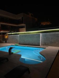 a swimming pool in the middle of a building at night at Amber Terrace - Torrevieja in Torrevieja