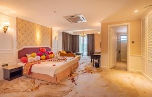 a hotel room with a large bed with a dirty floor at Tasik Villa International Resort in Port Dickson