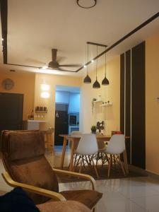 a living room and kitchen with a table and chairs at Bayu D'Awan Muslim Homestay Putrajaya in Putrajaya