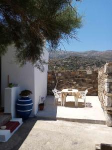 a table and chairs on a patio with a view at Spilios House in Apollon