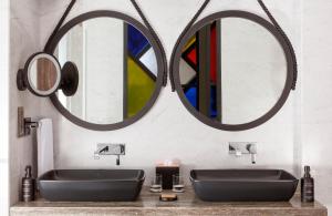 ein Badezimmer mit zwei Waschbecken und zwei Spiegeln in der Unterkunft Andaz Residence by Hyatt - Palm Jumeirah in Dubai