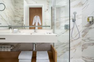 a bathroom with a sink and a shower at Alma Health & Spa Retreat in Brăila