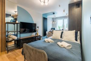 a bedroom with a bed with two towels on it at Golden Seaside Beach - 200m from the sea in Gdańsk