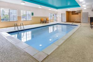 a large swimming pool with blue water in a building at La Quinta Inn & Suites by Wyndham Norfolk in Norfolk