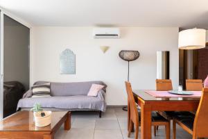 a living room with a table and a couch at Santa Luzia Green Apartment in Santa Luzia