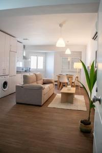 a living room with a couch and a table at California Apartament Dueñas in Seville