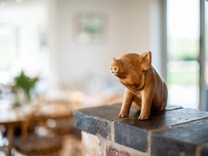 a small cat figurine sitting on a brick pillar at Pass the Keys Peaceful Countryside Residence in Pershore