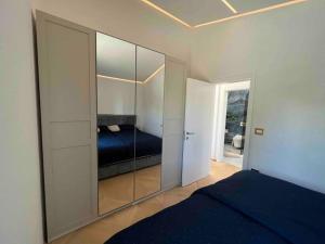 a bedroom with a mirrored closet with a bed in it at Sea view 2 bedroom apartment in Portorož