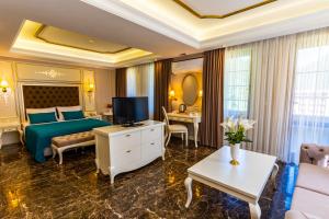 a hotel room with a bed and a tv at Flora Uzungöl Resort Hotel in Uzungol +61 photos