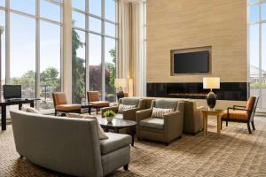 a living room with a couch and chairs and a tv at Wyndham Avon in Avon Center