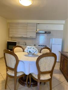 a kitchen with a table with a bowl of flowers on it at Casa di Antonia in San Marzano sul Sarno