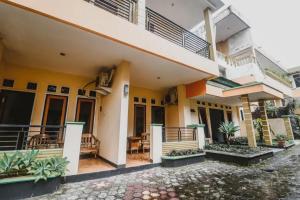 a view of a house with a balcony at RedDoorz Plus at Neo Asri Hotel Megamendung Puncak Bogor in Bogor