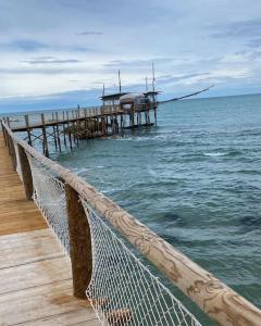 a pier in the ocean next to the water at Taverna Bucciante in Fossacesia