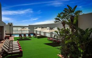德班的住宿－宜容格尼瑪哈拉尼酒店，一座带草坪、椅子和遮阳伞的建筑