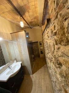 baño con lavabo y pared de piedra en Taverna Bucciante en Fossacesia