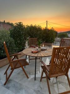 a wooden table and two chairs on a patio at Marble's Residence in Argostoli