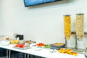 a buffet with several plates of food on a table at New Amaryllis Hotel in Athens