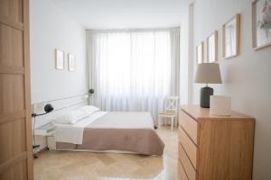 a white bedroom with a bed and a window at Dall Arca Smart Flat - Central Station Checkpoint in Bari