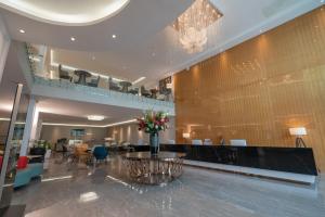 a lobby with a table with a vase of flowers at Stay Easy Plus Hotel in Addis Ababa