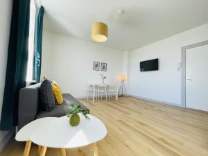 a living room with a couch and a table at aday - Green Light Apartment Suite in the center of Hjorring in Hjørring