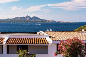 a house with a view of the ocean and mountains at Villa Rena Bianca in Baja Sardinia