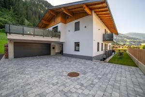 a house with a balcony and a driveway at Apartment Hoflacher in Schwendau