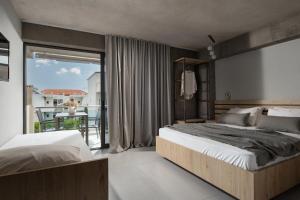 A bed or beds in a room at Erifili at Sarti Agora Apartments & Studios