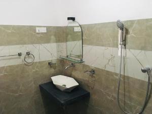 a bathroom with a shower with a toilet and a sink at Green Bird Villas in Kandy