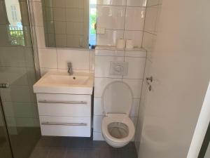 a bathroom with a toilet and a sink at Oslo apartment center in Oslo