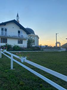 a white fence in front of a house at Hill House Emir in Bihać