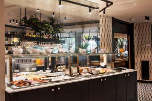 a buffet line with food on display in a restaurant at Acta CITY47 in Barcelona