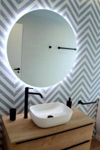 a bathroom with a white sink and a mirror at La Marina in Sant Carles de la Ràpita