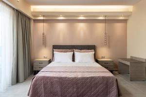a bedroom with a large bed with two night stands at Lampraki Luxury Apartments in Rhodes Town