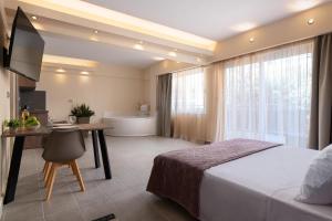 a bedroom with a bed and a bathroom with a tub at Lampraki Luxury Apartments in Rhodes Town