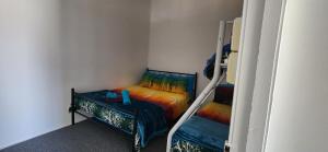 a small room with two bunk beds in it at Golden Mt Rest off Pepperina Lane in Mount Morgan