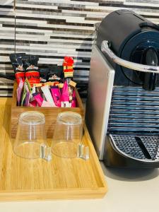 a wooden cutting board next to a toaster and a box of food at Haneemanim Apartments in Haifa