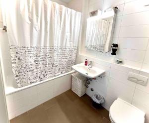 a bathroom with a sink and a shower curtain at CH Apartment Lausanne Gare in Lausanne