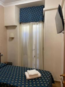 ein Hotelzimmer mit einem Bett und einem Fenster in der Unterkunft Bye Rome Guesthouse in Rom