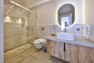a bathroom with a sink and a shower and a toilet at Born in Blue in Kaş