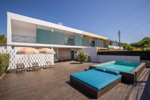 a house with a swimming pool on a deck at Beautiful Boutique House Near the Beach in Costa da Caparica
