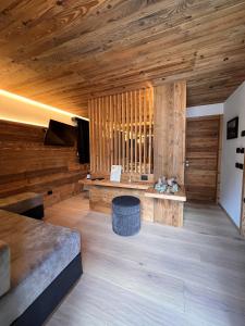 a large room with wooden walls and a wooden floor at Chalet Queen in Canazei