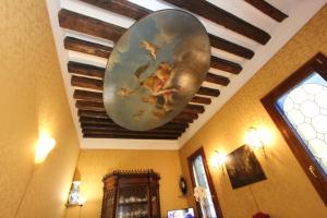 a painting on the ceiling of a room at City Apartments Rialto Market in Venice